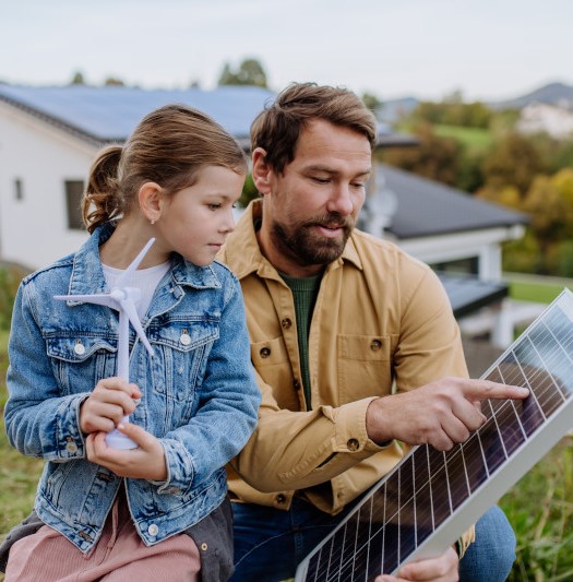 father and daughter on a farm looking at renewable energy